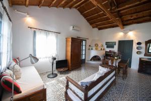 a living room with a couch and a table at Aegean Dream in Klíma