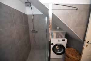 a bathroom with a shower and a washing machine at Aegean Dream in Klíma +27 photos