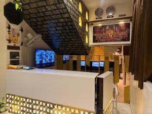 a room with a bar with a tv and a counter at Hotel SK Chakan Pune in Dehu