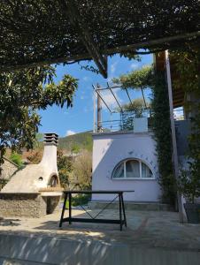 a picnic table in front of a building with a stove at La Campagne Ioannina Kranoula in Ioannina