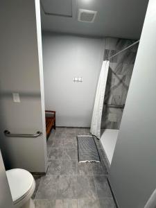 a bathroom with a toilet and a tile floor at Germantown Inn & Lounge in Hermann +2 photos