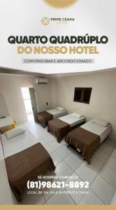 a room with two beds and a sign for a hotel at Hotel Prime Ceaka in Caruaru