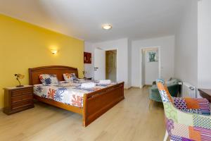 a bedroom with a bed and a chair at Nice double bedroom in beautiful Quinta - QR06 in Lagos