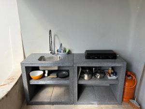 a small kitchen with a sink and a stove at Great double bedroom in beautiful Quinta - QR07 in Lagos