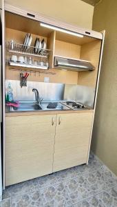 a kitchen with a sink and a counter top at Malandris Studios in Skala Marion +22 photos