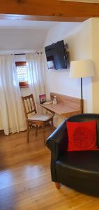 a living room with a couch and a table at Gästehaus Holzer Kreuz - Ferienwohnung "Narzisse" in Fröhnd +8 photos
