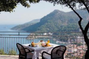 a table with food on it with a view of a mountain at Loryma Resort Hotel in Turunç +112 photos