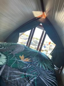 a bed in a room with a window at deBieslodge in Drimmelen