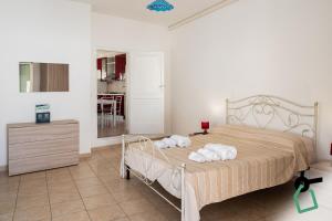 a bedroom with a bed with towels on it at Hotiday Gallipoli Castello in Gallipoli