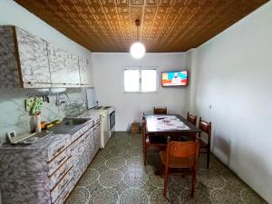 a kitchen with a table and a sink and a table and chairs at Kuca Denic in Svrljig