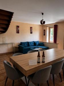 a living room with a table and a blue couch at Logis Hotel restaurant de la Poste in Pontgibaud