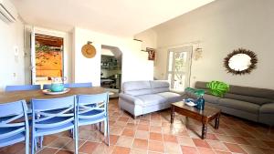 a living room with a couch and a table at Villa Edo Cefalù in Cefalù