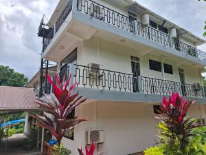 a building with a balcony and some plants at G4 homez in Morogoro