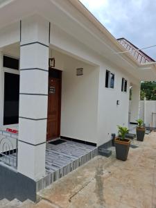 a houserendering of a home with a front door at G4 homez in Morogoro