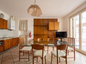 ein Esszimmer mit einem Glastisch und Stühlen in der Unterkunft Central Duplex in Iseo - 2 Bedrooms - Private Parking & WiFi in Iseo