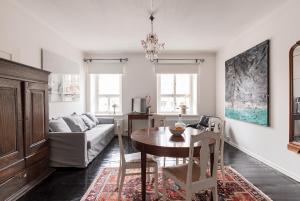 a living room with a table and a couch at Artist Apartment Susi in Helsinki