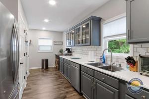 a kitchen with gray cabinets and a sink at Charming Pet-Friendly Lake Retreat in Lake Geneva +15 photos