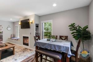 a dining room with a table and a fireplace at Charming Pet-Friendly Lake Retreat in Lake Geneva