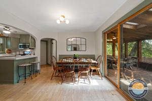 a kitchen and dining room with a table and chairs at Lake Geneva Escape 4BR Arcade Fire Pit and Deck in Lake Geneva +39 photos