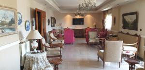 a living room filled with furniture and a chandelier at Luxury Appartement in Trâblous