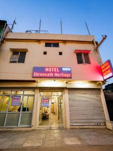 a building with a hotel superstar healthcare sign on it at Hotel Shreenath Heritage in Ujjain