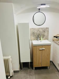 a bathroom with a sink and a mirror at Ile Rousse in LʼÎle-Rousse