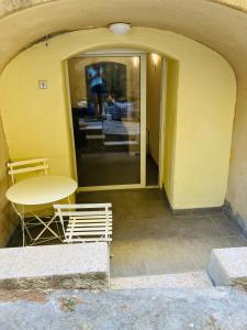 a room with a table and chairs in a building at Ile Rousse in LʼÎle-Rousse