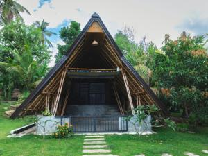 a small house with a thatched roof at Lake View Cabana near Tangalle in Tangalle