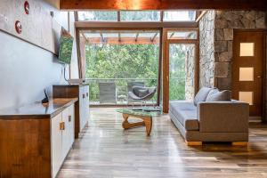 a living room with a couch and a chair at Rochester Bariloche Suites & Spa in San Carlos de Bariloche