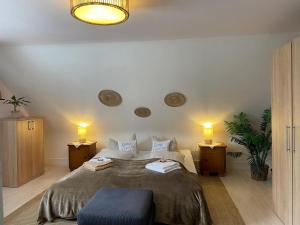 a bedroom with a large bed with two night stands at Gästehaus Sandvoss in Titisee-Neustadt