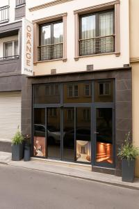 a store front with windows and plants on the street at Orange Hotel & Spa in Şişli