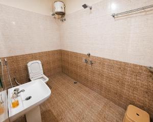 a bathroom with a sink and a toilet at Hotel Shreenath Heritage in Ujjain +17 photos