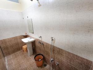 a bathroom with a sink and a shower at Hotel Shreenath Heritage in Ujjain