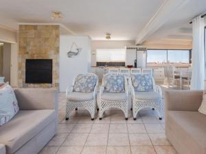 a living room with a couch and a table and chairs at Ocean View 147 in Struisbaai