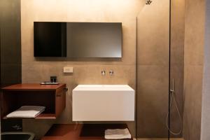 a bathroom with a white sink and a mirror at Ku Private Milano in Pero