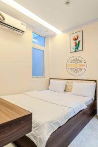 a large bed in a room with a window at Sao Việt Nam Hotel in Ho Chi Minh City