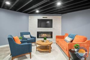 a living room with two couches and a fireplace at Exclusive Lake Como Escape with Bar and Pool Table in Lake Geneva +20 photos