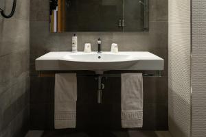 a bathroom with a white sink and a mirror at Alda Ruta Castilla in Palencia