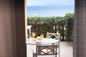 a table with glasses of orange juice on a patio at Apartmani Enna in Mali Lošinj