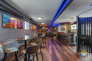a restaurant with tables and chairs and a bar at Event Lounge with Pool Table and Arcade in Lake Geneva