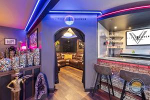 a room with a bar with a couch in it at Event Lounge with Pool Table and Arcade in Lake Geneva