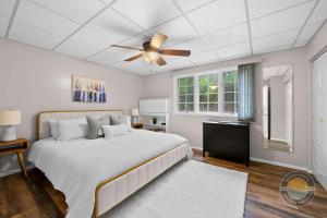 a bedroom with a bed and a ceiling fan at Lake Como Condo with Lake Views and Pool in Lake Geneva