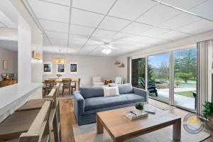 a living room with a couch and a table at Lake Como Condo with Lake Views and Pool in Lake Geneva