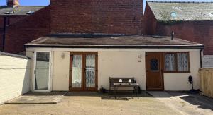 a small house with a bench in front of it at Casa G in Bridlington