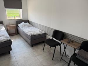 a room with two beds and a table and chairs at Kwatery Smroków in Smroków