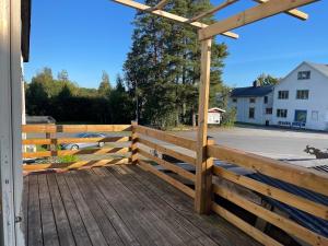 a wooden deck with a fence and a carport at Gästis in Sollefteå +1 photo