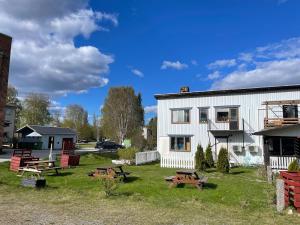 a group of picnic tables in front of a building at Gästis in Sollefteå