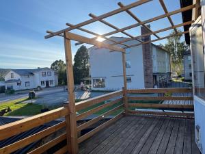 a wooden deck with a wooden pergola at Gästis in Sollefteå