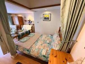 a small bedroom with a bed and a couch at Casa G in Bridlington