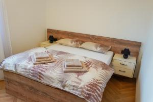 a bedroom with a bed with two towels on it at Casa Oliva Tivat in Tivat